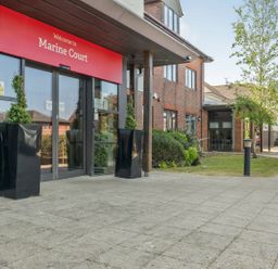 An entrance with a sign at Marine Court in Littlehampton
