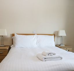 A bedroom with a bed and lamps at Bedroom 9 in Littlehampton