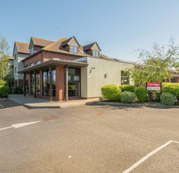 A building entrance with parking and signage at Marine Court First Floor Double with Shower Room Littlehampton