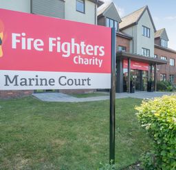 A sign for Fire Fighters Charity at Marine Court in Littlehampton