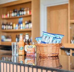 A bar with drinks and snacks at Marine Court First-floor Double Bedroom with Wet Room in Littlehampton
