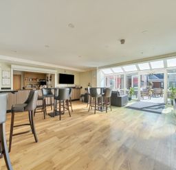 A bar area with tables and chairs at Marine Court First-floor Double Bedroom with Wet Room Littlehampton