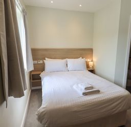 A bedroom with a double bed and en-suite bathroom at Eamont Park First-floor Double Bedroom in Penrith