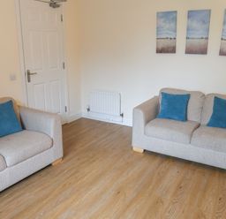 A living room with two sofas and wall art at Bungalow 15 Eamont Park Penrith