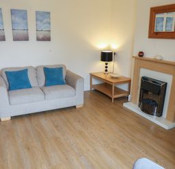 A living room with a sofa and fireplace at Bungalow 15 Eamont Park Penrith