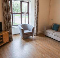 A living room with a sofa and armchair at Bungalow 15 Eamont Park in Penrith