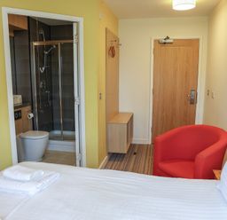 A bedroom with a bed and shower area at Bedroom 7 in Penrith