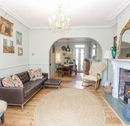 A living room with a sofa and a dining area at 18 Pakefield Road in Lowestoft
