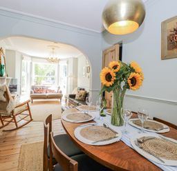 A dining room with a table set for dinner at 18 Pakefield Road in Lowestoft