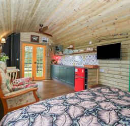 A studio with a bed and kitchen area at Shepherd Hut’s Bristol