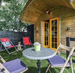 An outdoor seating area with chairs and a table at Shepherd Hut’s in Bristol