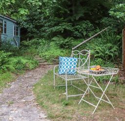 An outdoor seating area with a chair and table at The Boat House in Ashprington