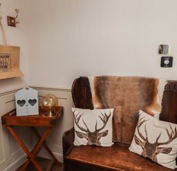 An entrance with a bench and decorative items at Craster House in Seahouses