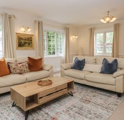 A living room with sofas and a coffee table at Cumbria house