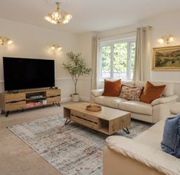 A living room with a television and coffee table at Cumbria house