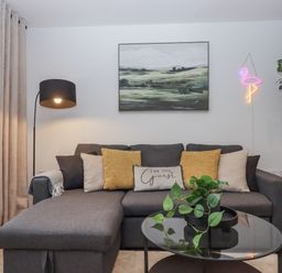 A living room with a sofa and a coffee table at Milana in Tiverton