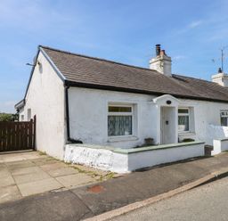 A white single-story house with a tiled roof and small front garden at Cobweb Cottage in Waunfawr