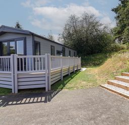 A house with a decking area and steps at The Pines 2 Bedrooms Delamere