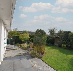A garden with grass and a shed at 42 Little Trelyn in Wadebridge