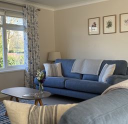 A living room with a sofa and coffee table at 42 Little Trelyn, Rock