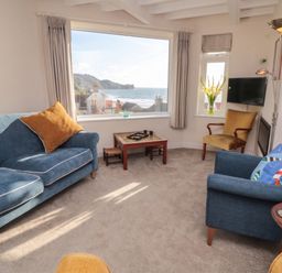A living room with a view and furniture at Iveridge in Sandsend