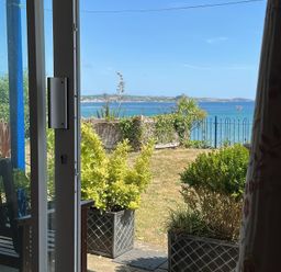 An outdoor view featuring a bench and plants at 1 Penrose Court Penzance