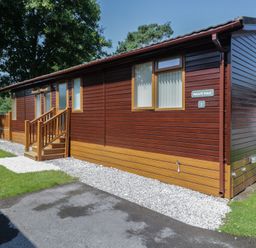 An outdoor view of a cabin with steps and a pathway at Wally's Folly near Limefitt Park