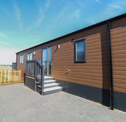 An outdoor area with a steps and a door at Sand & Serenity in Bacton