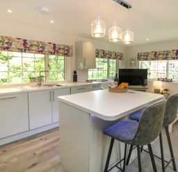 A kitchen with a countertop and stools at Stoney Rock Lodge