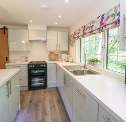 A kitchen with cabinets and a sink at Stoney Rock Lodge 