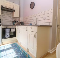 A kitchen with appliances and a sink at The Cow Shed