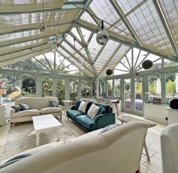 A conservatory with sofas and a coffee table at Trenare in Truro