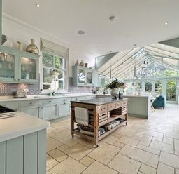 A kitchen with cabinets and a large island at Trenare in Truro
