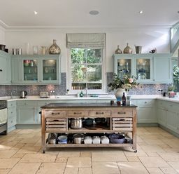 A kitchen with cabinets and an island at Trenare in Truro