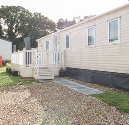 An outdoor area with a mobile home and deck at Number 34 Foxburrow Hang Great Yarmouth