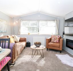 A living room with a sofa and armchair at Number 34 Foxburrow Hang in Great Yarmouth
