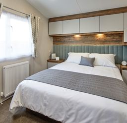A bedroom with a bed and bedside table at Island Breeze - Hayling Island