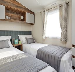 A bedroom with two beds and a window at Island Breeze - Hayling Island