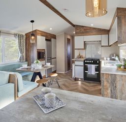 A kitchen with seating area and appliances at Island Breeze - Hayling Island
