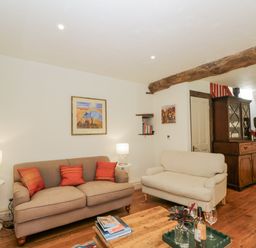A living room with a sofa and coffee table at Stable cottage Sopworth near Sherston