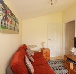 A living room with a sofa and television at 101 Atlantic Bays Holiday Park in Padstow