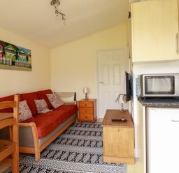 A living room with a sofa and a coffee table at 101 Atlantic Bays Holiday Park in Padstow