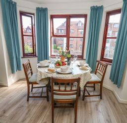 A dining room with a table set for a meal at Flat 9 in Swanage