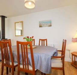 A dining room with a table and chairs at Folly View in Cambrose near Illogan