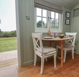 A dining area with a table and chairs at Shepherd's Hut in Wrexham