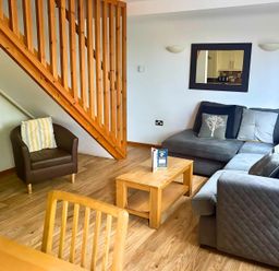 A living room with a sofa and coffee table at Acorn Lodge near Finlakes Holiday Park