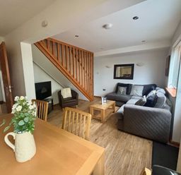 A living room with a sofa and coffee table at Acorn Lodge Finlakes Holiday Park near Chudleigh