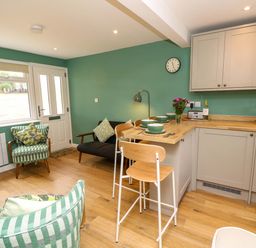 A kitchen with a table and chairs at No 157 Sandown Bay Holiday Chalet 'Field View' Sandown