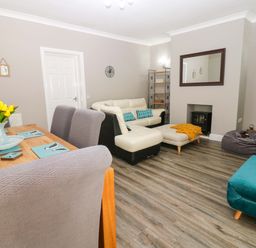 A living room and dining area with furniture at Amblers Rest in Amble