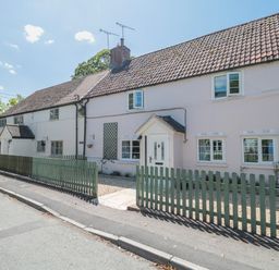 A house with a picket fence and pathway at Old Farm Cottage in Warminster